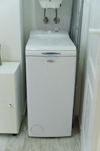 a small white refrigerator in a room with a sink at Lara free parking Skadarlija in Belgrade