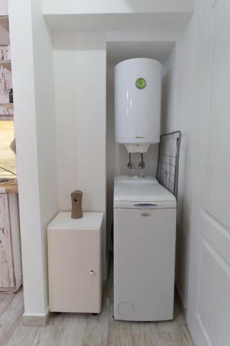 a kitchen with a coffee maker on top of a refrigerator at Lara free parking Skadarlija in Belgrade