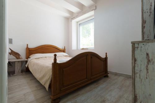 a bedroom with a wooden bed and a window at Lara free parking Skadarlija in Belgrade