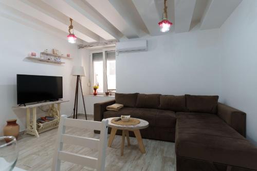 a living room with a brown couch and a table at Lara free parking Skadarlija in Belgrade