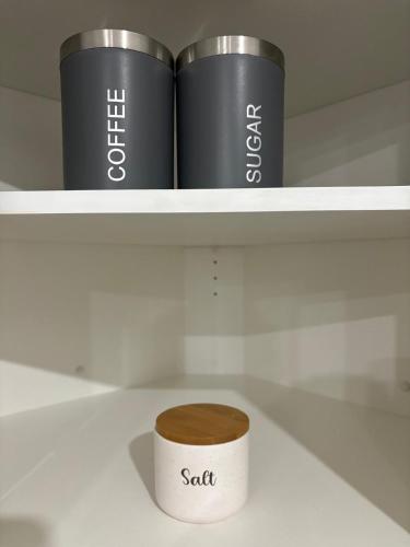 a roll of toilet paper sitting on a shelf at Stylish and Cozy Guest Suite in Calgary