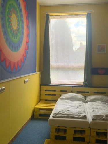 a small room with a bed and a window at Family Paradise Huslenky in Huslenky