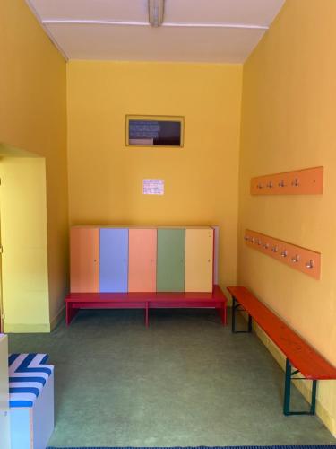 a room with colorful cabinets and a bench at Family Paradise Huslenky in Huslenky