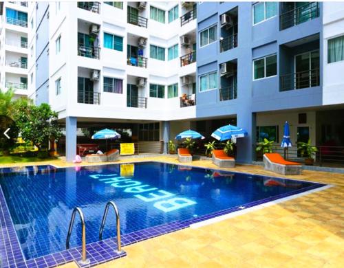 a large swimming pool in front of a building at Beach condo Jomtien 12 SuperHost in Jomtien Beach