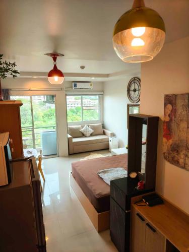 a living room with a bed and a couch at Beach condo Jomtien 12 SuperHost in Jomtien Beach