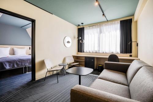 a hotel room with a couch and a bed at Citybox Brussels in Brussels