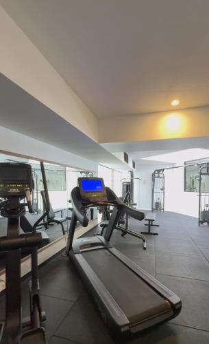 a gym with several tread machines in a room at Lakes Hotel in Adelaide