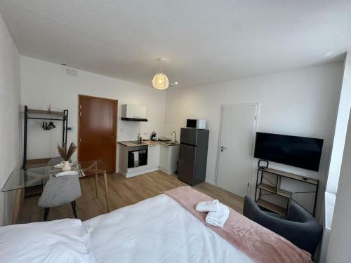 une chambre d'hôtel avec un lit et une cuisine dans l'établissement Le studio Champêtre, à Mulhouse