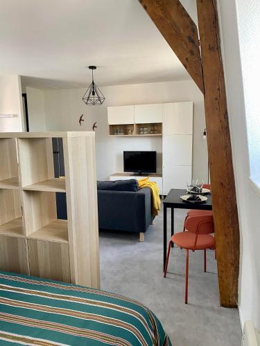 a living room with a blue couch and a table at L'écrin du général in Armentières