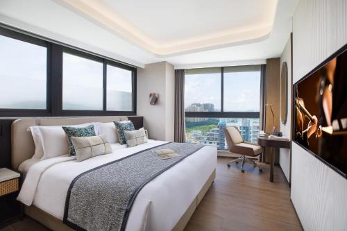 Postel nebo postele na pokoji v ubytování Ascott Dadonghai Bay Sanya