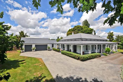 a large white building with a garage at Villa Shakespeare in Cambridge