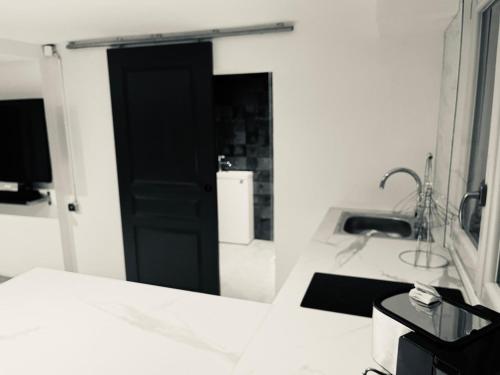 a bathroom with a black door and a sink at Chic and Peaceful apartment Roissy Charles de Gaulle Airport 15mins-Parc des Expositions Villepinte 10mins- Disneyland 30mins in Tremblay En France