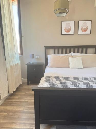 a bedroom with a bed with a black and white comforter at MAISON REBECCA in Carpi
