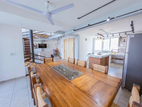 a large room with a wooden table and a kitchen at Comfortable Retreat in Cocoyoc Pool & BBQ in Cocoyoc