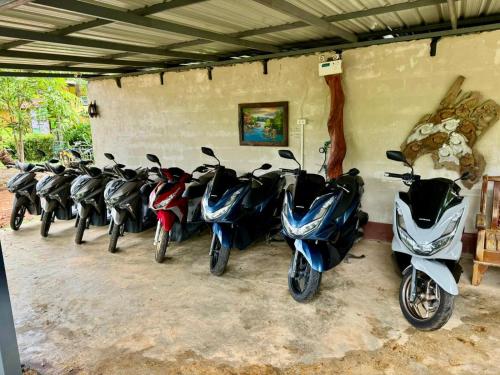 a row of motorcycles parked in a garage at Fine Times Resort in Ko Chang