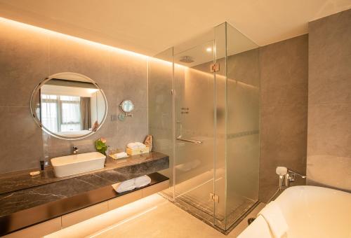 a bathroom with a shower and a toilet and a sink at Lia Charlton Hotel Shenzhen in Shenzhen