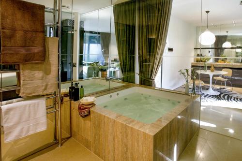 a bathroom with a jacuzzi tub in a room at Hepburn at Hepburn in Hepburn Springs