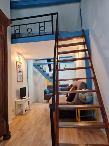 une chambre avec un lit superposé et un escalier dans l'établissement La Maison-frite, pour un séjour insolite à Foix !, à Foix