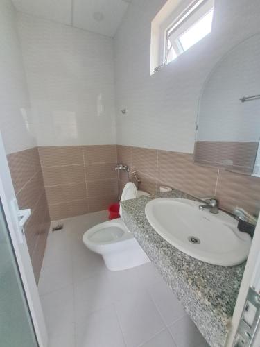 a bathroom with a sink and a toilet at MrLee Dalat House in Da Lat