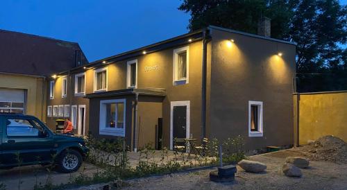 a house with a car parked in front of it at Pension Flughafen Leipzig in Freiroda