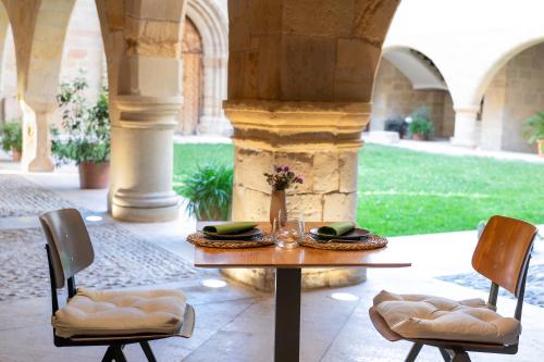 a table and two chairs in a patio with a table at Santuario Virgen de la Fuente in Peñarroya de Tastavins