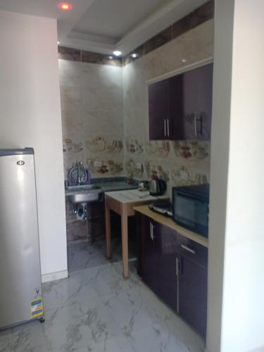 a kitchen with a sink and a counter top at A two-room chalet in the village of Lale Land, Mirage Bay, Ecopark in Hurghada