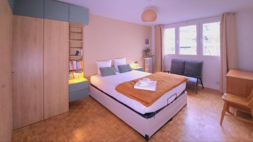 une chambre avec un lit et une chaise dedans dans l'établissement 3 chambres renove climatise quartier Latin & Seine, à Paris