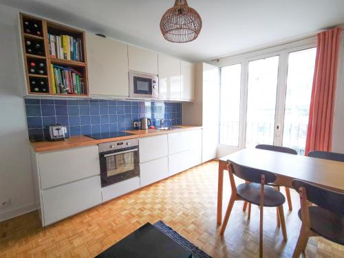 - une cuisine avec une table, une table et des chaises dans l'établissement 3 chambres renove climatise quartier Latin & Seine, à Paris