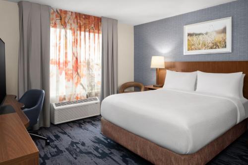 a hotel room with a bed and a window at Fairfield Inn Fort Leonard Wood St. Robert in Saint Robert