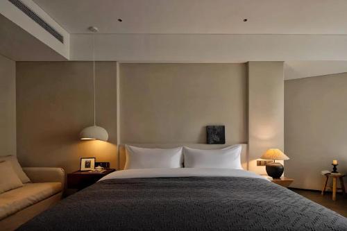 a bedroom with a large bed and a couch at Phoenix Hall House Hotel in Fenghuang