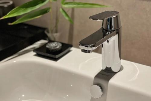 a sink with a faucet on top of it at Phoenix Hall House Hotel in Fenghuang