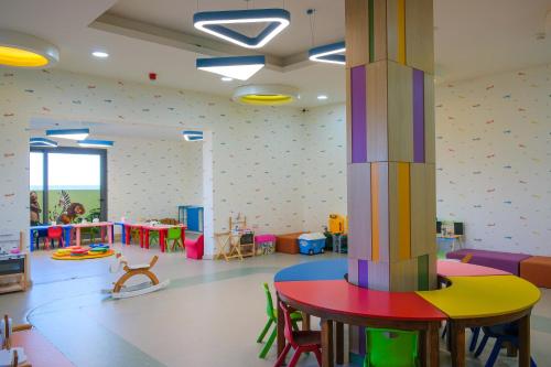 a nursery with a room with colorful tables and chairs at The Arkin Iskele in Iskele