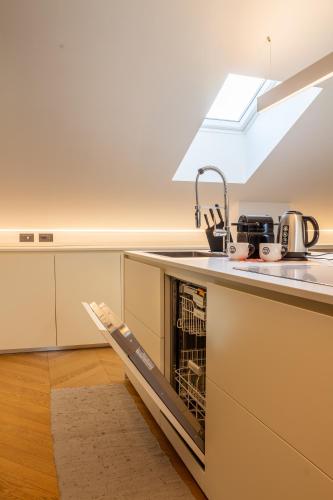 a kitchen with a sink and a dishwasher at My cup of tea in Seregno