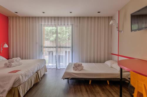a room with two beds with teddy bears on them at Logis Hôtel Domaine du Moulin Cavier - Restaurants & Spa in Avrillé