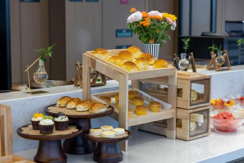 a display of pastries and cupcakes on a table at Atour Hotel Dongguan Huangjiang Xingguang Road in Dongguan