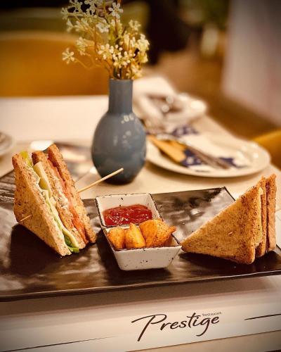 a tray with sandwiches and a bowl of ketchup at Hotel Mepas in Mostar