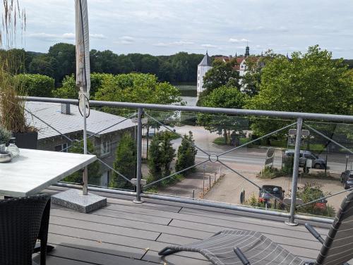 a balcony with a table and chairs and a view at Hotel am Wasserschloss Glücksburg in Glücksburg
