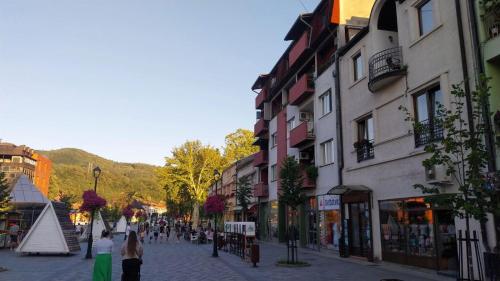 a group of people walking down a street with buildings at Hacijenda in Bajina Bašta