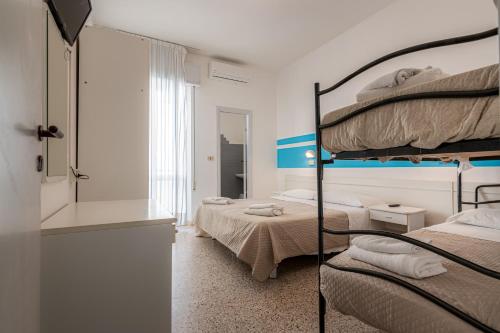 Postel nebo postele na pokoji v ubytování Hotel Serafini