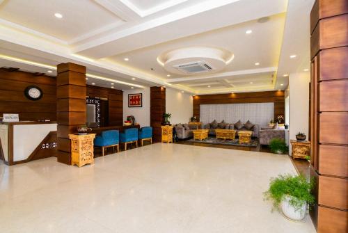 a lobby with a waiting room with blue chairs at Tsokar Retreat in Leh