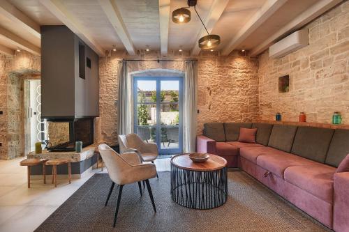 a living room with a couch and a table at Villa PI for 8 people in Central Istria with heated pool & large garden in Tinjan