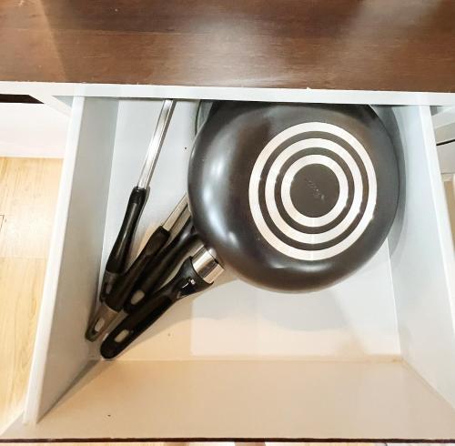 a target in a cabinet with some utensils at 2BR Holiday Suite Hat Yai in Hat Yai