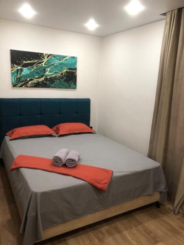 a bedroom with a bed with two towels on it at Бухар -Жырау 72 in Karagandy