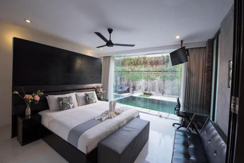 a bedroom with a large bed and a swimming pool at 20 off Special Brilliant Location in Seminyak