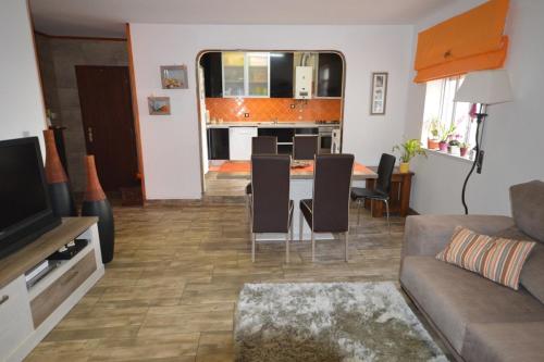 a living room with a couch and a table with chairs at Casa 33 in Lagos