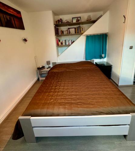 a bedroom with a large bed in a room at Emeraude in Gex