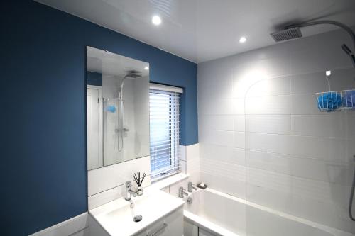 a bathroom with a white sink and a shower at 3 Bed House - Sleeps 6 - Parking - Pets - Garden in Rowlands Gill