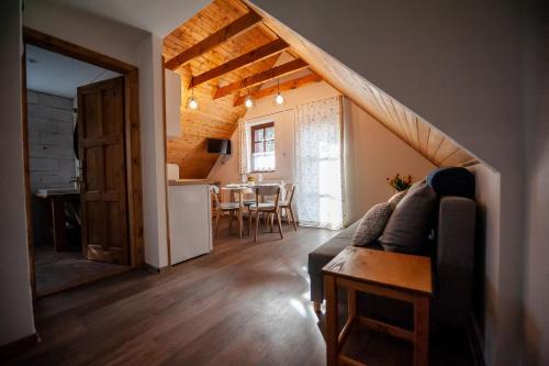 a living room with a couch and a dining room at Apartmán Stodola2 Harrachov in Harrachov