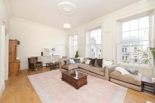 a living room with a couch and a table at JOIVY Exclusive house with free parking in Edinburgh