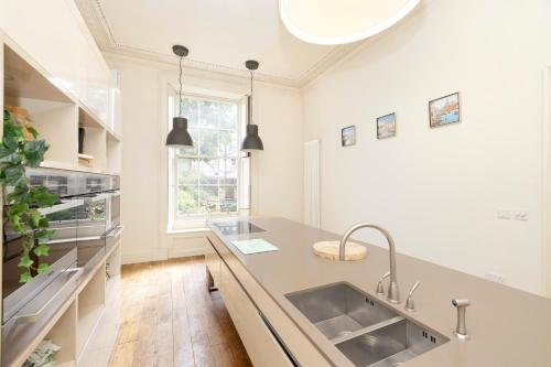 a kitchen with a sink and a counter at JOIVY Exclusive house with free parking in Edinburgh